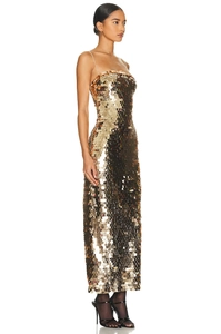 Detailed view of luxurious gold fish scale sequins on a slim-fit backless evening gown