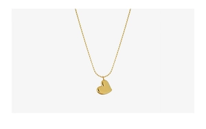 Detailed view of polished 18k gold plated heart pendant with fine chain on white background