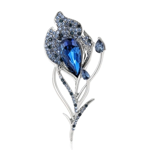Exquisite silver feather brooch with a large teardrop blue gem and rhinestones