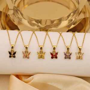 Detail of colorful zircon butterfly pendants on 18K gold plated titanium necklaces