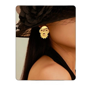 Close-up of model wearing 18k gold daisy earrings with black veil for a vintage look