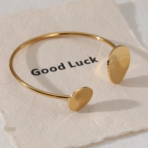 Adjustable golden stainless steel cuff bracelet with Good Luck engraving and polished finish