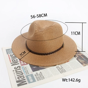 Detail of brown fedora straw hat showing fine weave texture and dark leather band