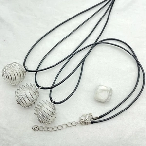 Detailed macro view of spiral wire cage pendants with white marble stones on wax cord
