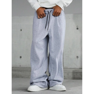 Men's retro wide-leg grey sweatpants with black drawstring in a relaxed street style