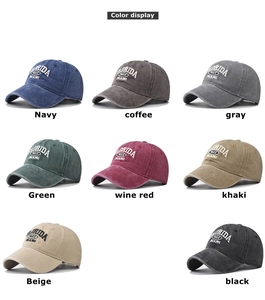 Detail view of washed cotton baseball caps showing Florida embroidery in multiple colors