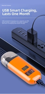 Detail of orange electric nose hair trimmer with USB port and digital power display