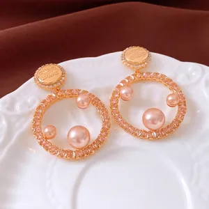 18K gold plated hoop earrings with pink pearls and vintage embossed logo detail