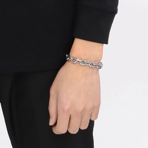 Detail of silver stainless steel chain bracelet with OT clasp on a model wrist