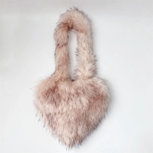 Detail of soft heart-shaped faux fur shell bag with fluffy pink and white long plush texture
