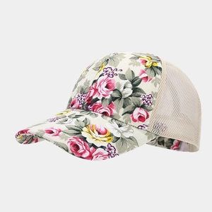 Detail of floral baseball cap with pink rose pattern and beige mesh panels for ventilation