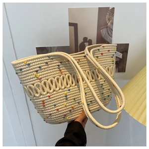 Detailed close-up of cream woven tote bag with colorful polka dots and thick cotton rope texture