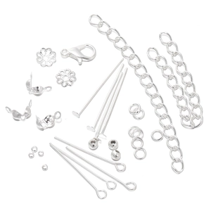 Detailed set of silver lobster clasps, eye pins, and jewelry making findings on white background