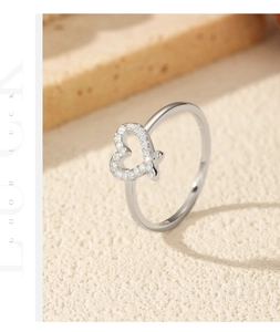Macro shot of silver S925 heart ring with pavé moissanite stones on frosted surface
