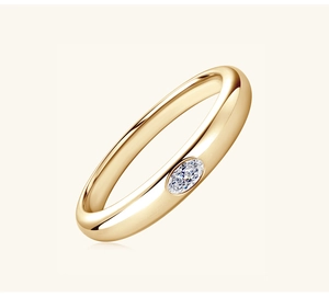 Detail of polished gold ring featuring a central oval-cut moissanite stone