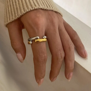 Modern two-tone stainless steel ring with zircon accents worn on finger