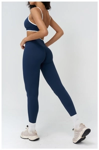 Detail view of navy blue yoga set with white contrast trim and high-waist fitness leggings