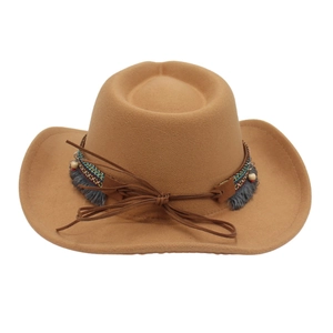 Close-up of a brown felt ethnic hat with colorful beads, tassels and woven bands