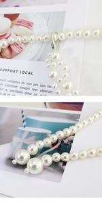 Macro detail of elegant white pearl chain with silver metal clasps and size gradient design