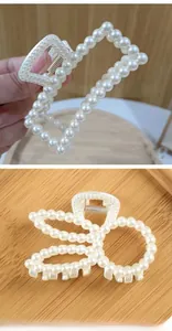 Detail view of large pearl hair claws in rectangular and butterfly shapes for women