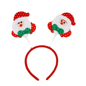 Detail of Christmas headband with red spring-mounted Santa dolls and green sequin bows