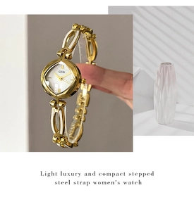 Macro shot of GEDI women's watch featuring mother of pearl inlay and gold steel strap
