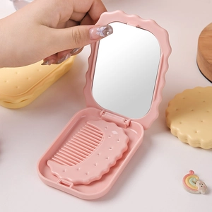 Pink biscuit-shaped folding cosmetic mirror and mini comb set for portable makeup use