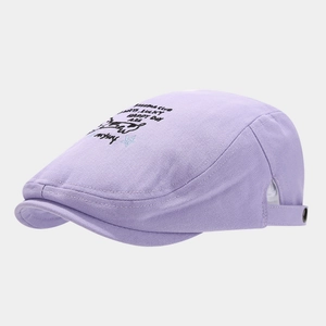 Detail of lavender cotton beret featuring black star and FELEMA CLUB letter embroidery