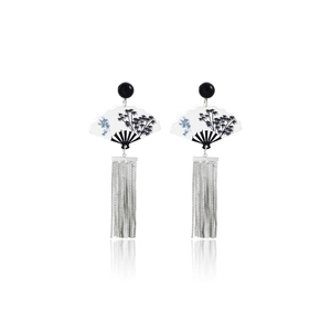 Detail of fan-shaped earring with black beads and long silver metallic tassels