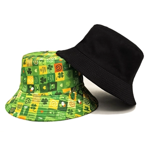 Reversible St. Patrick's Day bucket hat with green clover print and black solid color
