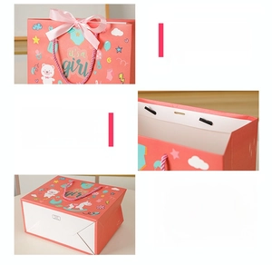 Detail of pink 'it's a girl' gift bag showing ribbon handles and reinforced bottom