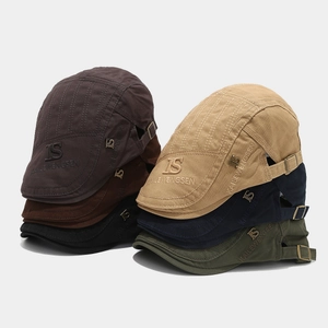 Detailed close-up of multiple vintage cotton canvas ivy caps with metal side buckles