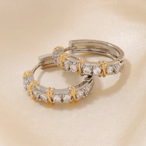 Elegant silver hoop earrings with gold X-shaped crossover and white zircons on silk
