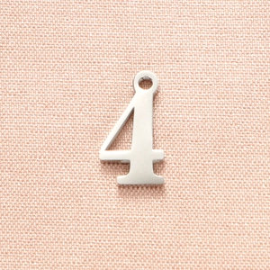 Macro detail of polished stainless steel number 4 pendant for DIY jewelry making