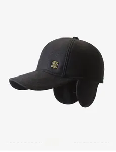Detail of winter wool baseball cap featuring golden badge and foldable ear flaps