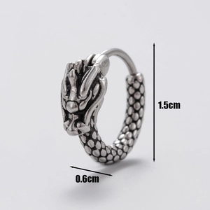 Macro view of vintage silver dragon earrings with detailed scales and 1.5cm height