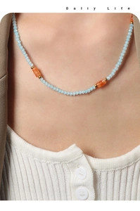 Gros plan d'un collier de perles turquoise fait main avec entretoises dorées en titane