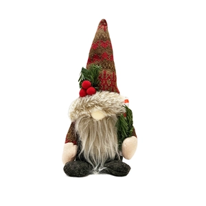 Christmas gnome doll with red knitted hat and pine branch ornament on white background