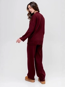 Burgundy knit two-piece set featuring long sleeve crewneck top and straight pants