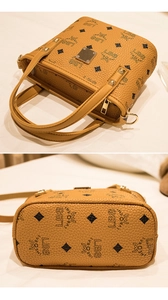 Close-up of brown bucket bag showing LBS monogram print and rivet detail