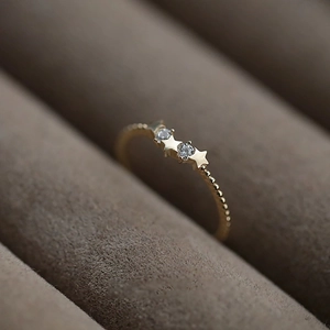 Elegant 14k gold plated silver ring with sparkling stars and zircon on a velvet case