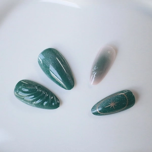 3D cat eye emerald green almond press-on nails with glitter and gold star design