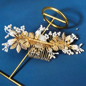 Elegant Chinese bridal hair comb with gold floral leaves and white pearls on stand