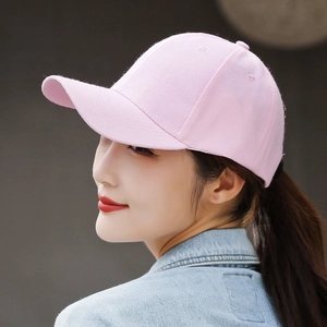 Detailed side view of a pink cotton baseball cap worn by a model for a casual look