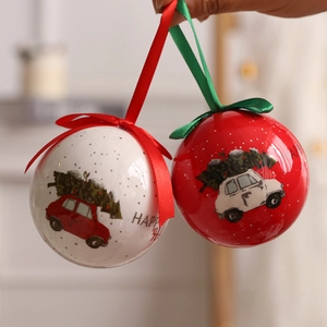 Christmas hanging ball with vintage car print and festive ribbon in warm indoor setting