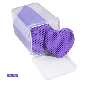 Close-up of purple heart-shaped lint-free wipes in a transparent storage box for eyelash glue