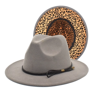 Detailed close-up of fedora hat showing grey felt texture and leopard print brim underside