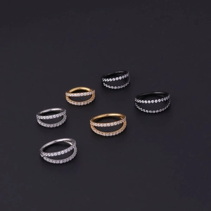 Close-up of double-row paved zircon seamless hinged rings in silver, gold, and black finishes