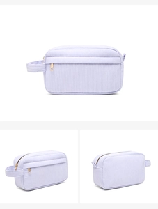 Detail view of lavender corduroy makeup bag with zipper closure and side carrying strap