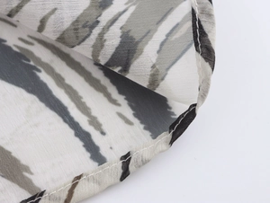 Close-up of chiffon leopard print fabric showing professional stitching on the hemline